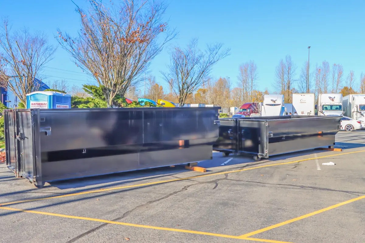 Professional dumpster rental service with roll-off container on residential driveway in Fanwood
